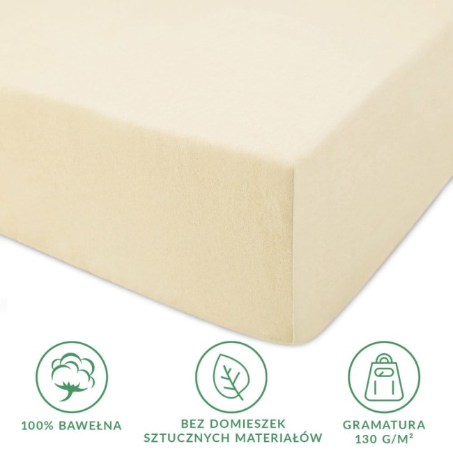 Prześcieradło jersey z gumką w kolorze kremowym o wymiarach 80x160 cm, wykonane z 100% bawełny, leżące na białym tle. Widoczny detal gumki oraz tekstura materiału, bez domieszek sztucznych materiałów, gramatura 130 g/m².