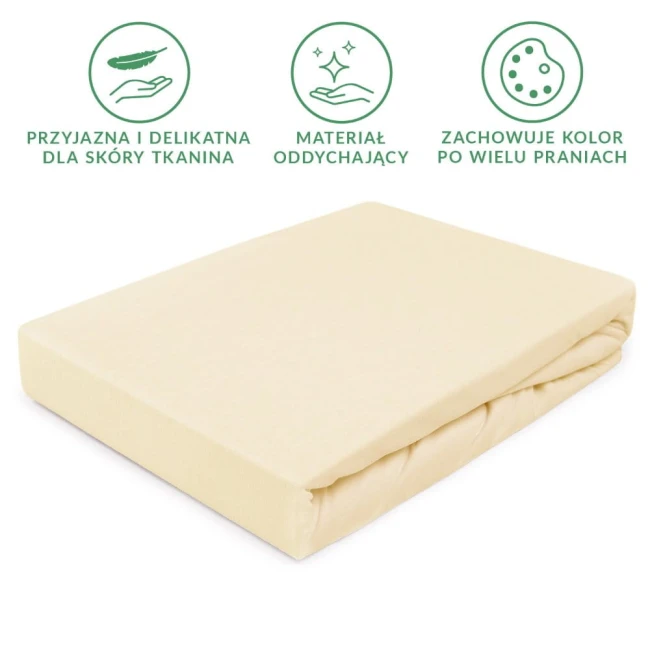 Prześcieradło jersey z gumką w kolorze kremowym o wymiarach 200x220 cm, leżące na jednolitym tle. Materiał jest gładki, elastyczny, z widoczną gumką na brzegu. Brak dodatkowych detali, bez napisów lub logo.
