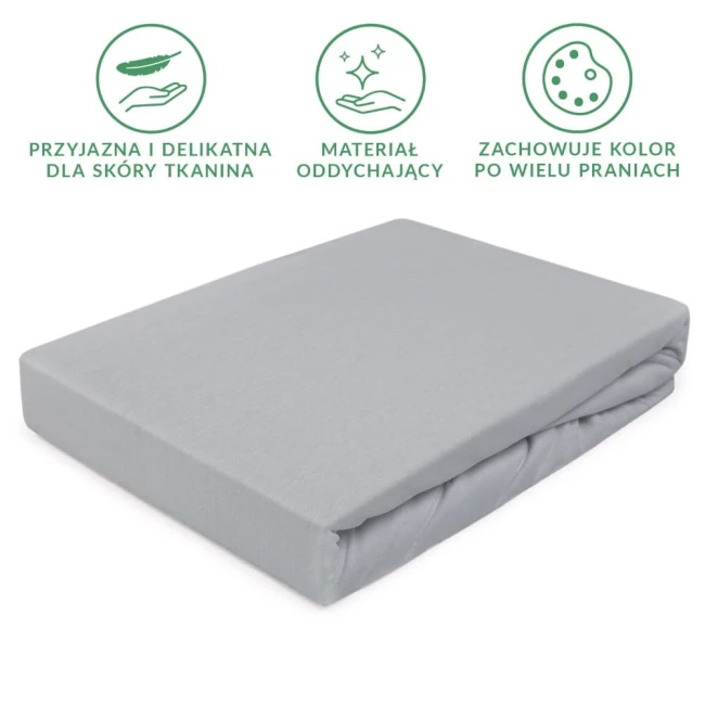 Prześcieradło jersey z gumką w kolorze popielatym, rozmiar 80x160 cm, leżące i złożone. Materiał oddychający, przyjazny dla skóry, z wyraźną, gładką fakturą. Na tle białym, bez zbędnych dekoracji.