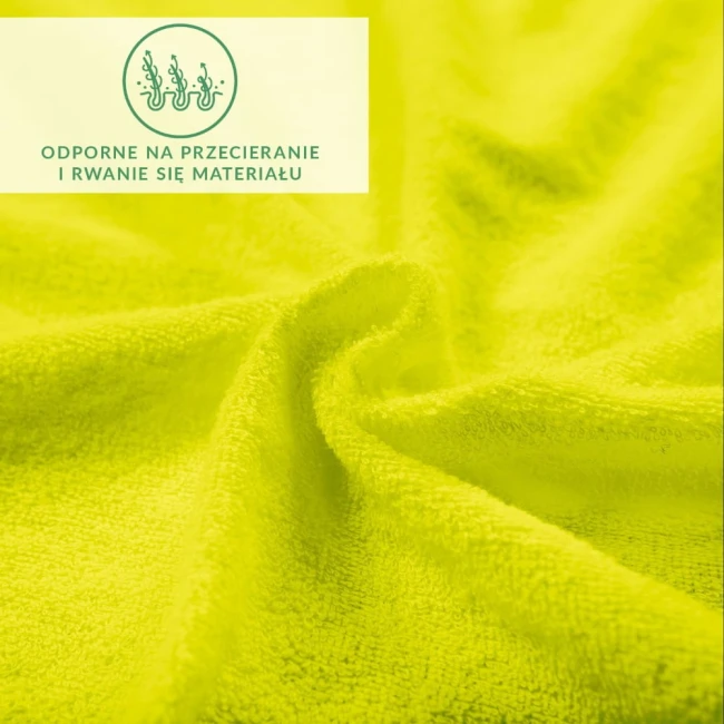 Prześcieradło frotte 140x200 w kolorze limonka, o miękkiej fakturze i wysokiej odporności na przetarcia. Ujęcie z bliska ukazuje detale tkaniny, podkreślając jej gładkość i intensywny kolor. W tle widoczny napis dotyczący właściwości materiału.