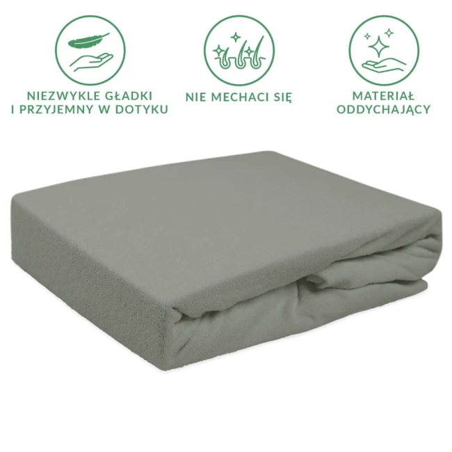 Prześcieradło frotte z gumką 140x200 w kolorze szarym, leżące na płasko. Wykonane z miękkiego, oddychającego materiału, z gładką fakturą. Widoczne złożenie wzdłuż krawędzi. Idealne do łóżek o wymiarach 140x200 cm.