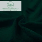 Prześcieradło frotte z gumką w kolorze zieleni butelkowej, o gładkiej teksturze, leżące na płasko. Widoczny detal materiału, podkreślający odporność na przetarcia i rwanie. Tło ciemne, minimalistyczne.