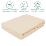 Prześcieradło jersey z gumką 140x200 w kolorze jasnego beżu leży płasko na białym tle. Wykonane z tkaniny przyjaznej dla skóry, ma delikatną, teksturowaną powierzchnię. Widoczne są podwinięcia, a gumka zapewnia dobrze dopasowane ułożenie na materacu.
