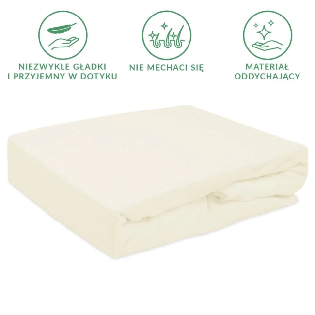 Prześcieradło frotte z gumką w kolorze ecru o wymiarach 90x200, leżące na białym tle. Materiał teksturowany, przyjemny w dotyku, z widoczną gumką na brzegu. Brak dodatkowych zdobień lub napisów.