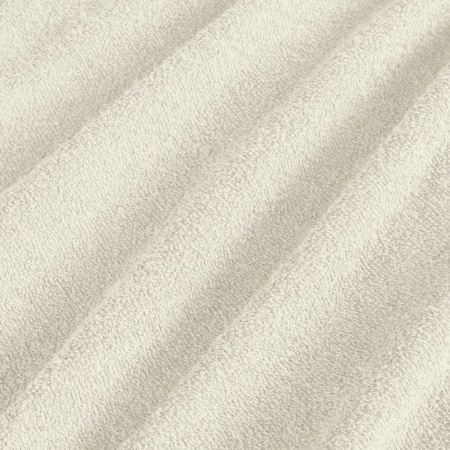 Poszewka frotte 40x80 w kolorze ecru, o miękkiej, teksturowanej powierzchni. Ujęcie z bliska, ukazujące delikatne przetłoczenia materiału. Idealna do poduszek, zapewniająca komfort i estetykę.
